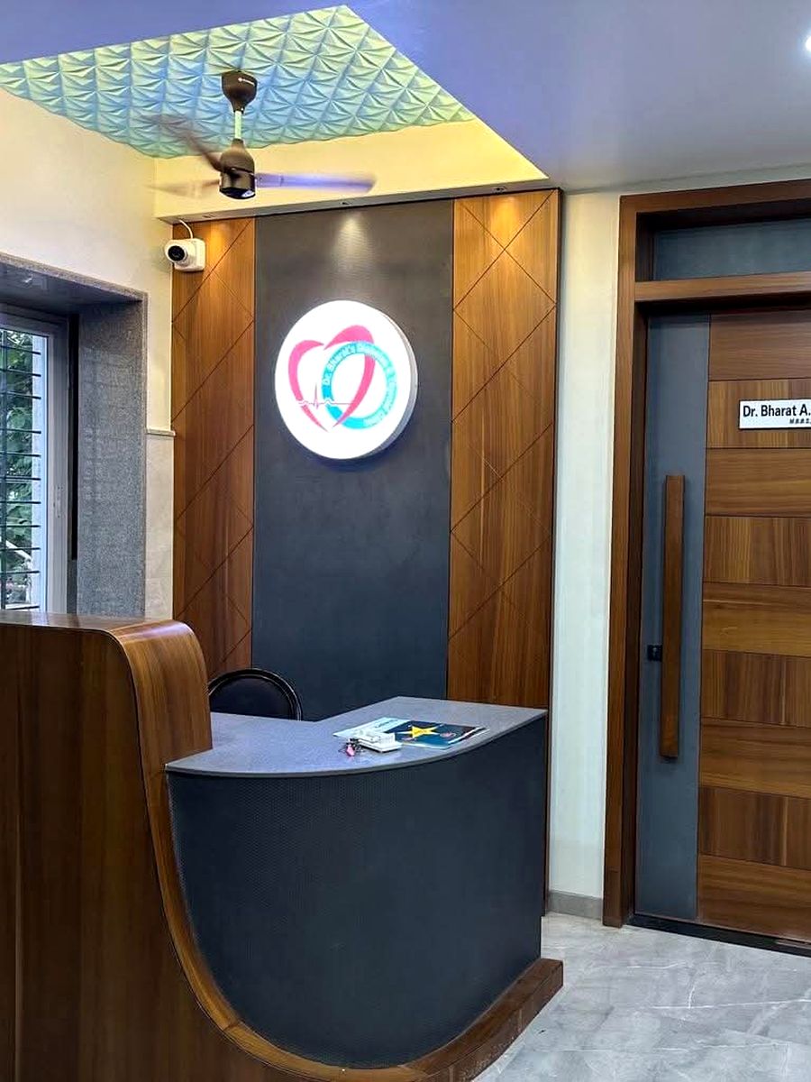 Reception desk with the clinic logo illuminated on the wall behind