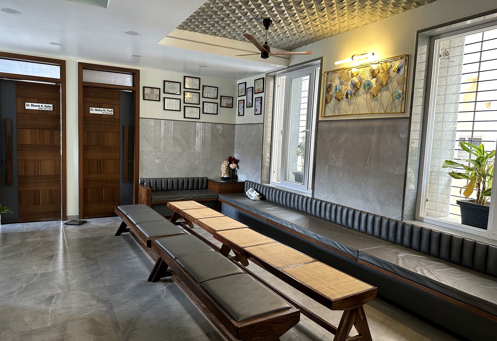 Framed degrees and certificates on the waiting room wall